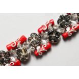 A SILVER, CORAL AND MOTHER-OF-PEARL FLOWER HEAD DESIGN BRACELET. 7.5ins long.