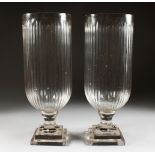 A PAIR OF LARGE CUT GLASS PEDESTAL STORM LANTERNS. 15.75ins.