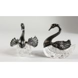 A PAIR OF SILVER AND CUT GLASS TABLE SALTS. 3ins long.