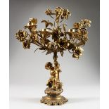 A LATE 19TH CENTURY ORMOLU SEVEN LIGHT CANDELABRA, modelled as a cherub holding aloft floral