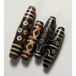 FOUR TIBETAN AGATE BEADS. 2.25ins and 3ins long.