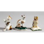 A SMALL PORCELAIN SEATED CAT, in the style of Chelsea, a cat and kitten, and a wise owl (3). 2.5