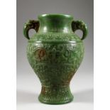 A CHINESE CARVED GREEN JADE VASE, with mythological beast handles. 7.5ins high.