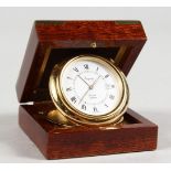 A SMALL ASPREY QUARTZ ALARM TRAVELLING CLOCK, in a wooden case. 2.25ins.