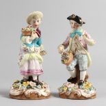A PAIR OF 19TH CENTURY DERBY FIGURES, a young boy and girl, each holding a basket of flowers. 6ins