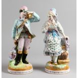 A PAIR OF LARGE CONTINENTAL PORCELAIN FIGURES, a hunter with his quarry and a lady by a fountain.