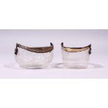 TWO CONTINENTAL CUT GLASS CIRCULAR BASKETS, with silver swing handles.