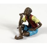 A VIENNA STYLE COLD PAINTED BRONZE OF A MAN SMOKING A PIPE. 2.25ins high.