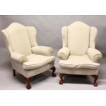 A GOOD PAIR OF GEORGE III DESIGN WING ARMCHAIRS, plain beige upholstery, on carved cabriole legs