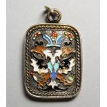A RUSSIAN SILVER AND ENAMEL DOUBLE EAGLE HEAD PENDANT. 1.5ins high.