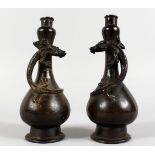 A GOOD SMALL PAIR OF CHINESE BRONZE GARLIC NECK BOTTLE VASE, each entwined with a lizard. 7ins