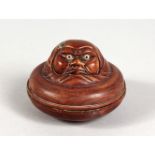 AN AMUSING JAPANESE CARVED WOOD CIRCULAR BOX. 2.5ins diameter.