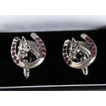 A PAIR OF SILVER RUBY SET HORSESHOE CUFFLINKS.