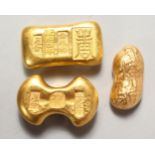 THREE NOVELTY CHINESE GOLDEN-COLOURED SCROLL WEIGHTS. 2ins and 2.5ins long.