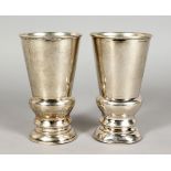 A PAIR OF CHINESE SILVER GOBLETS, stamped sterling C. J. Co. 5.25ins high.