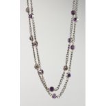 A SILVER AMETHYST SET LONG CHAIN.