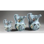 A GRADUATED SET OF THREE LATE 19TH CENTURY RIDGWAY JUGS, pale blue ground with floral decoration.