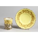 A ROYAL WORCESTER COFFEE CAN AND SAUCER, with pierced silver holder, yellow ground with gilt