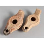 TWO SMALL TERRACOTTA OIL LAMPS.