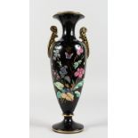 A VICTORIAN BLACK GLASS TWO-HANDLED VASE, painted with flowers and butterflies. 12ins high.