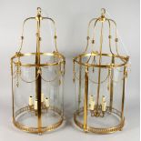 A LARGE PAIR OF BRASS HALL LANTERNS in the Georgian style. 32ins high.