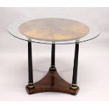 AN EMPIRE REVIVAL CIRCULAR MAHOGANY CENTRE TABLE, with three ebonised turned column supports on a