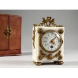 A GOOD LOUIS XVI DESIGN WHITE MARBLE CLOCK, with ormolu mounts. 5.5ins high, in a leather carrying