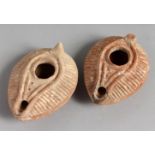 TWO SMALL TERRACOTTA OIL LAMPS.