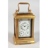 A SMALL SEVRES TYPE BRASS CARRIAGE CLOCK. 3ins high.