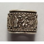 A CHINESE WHITE METAL ARCHERS RING. 1ins wide.