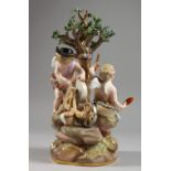 A MEISSEN PORCELAIN GROUP OF THE INFANT CUPID AND PSYCHE beneath a tree, cupid sharpening an