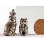 TWO CAST SILVER NOVELTY CATS with gem set eyes.