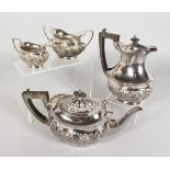 A FOUR PIECE EDWARDIAN SILVER TEA SET, with repousse decoration, comprising teapot, hot water jug,