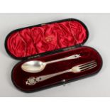 A WALKER & HALL SILVER CHRISTENING SPOON AND FORK in a fitted case. Chester 1906.