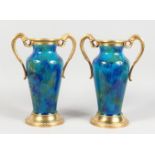 A GOOD PAIR OF 19TH CENTURY SEVRES BLUE PORCELAIN VASE, with ormolu handles and bases. 13ins high.
