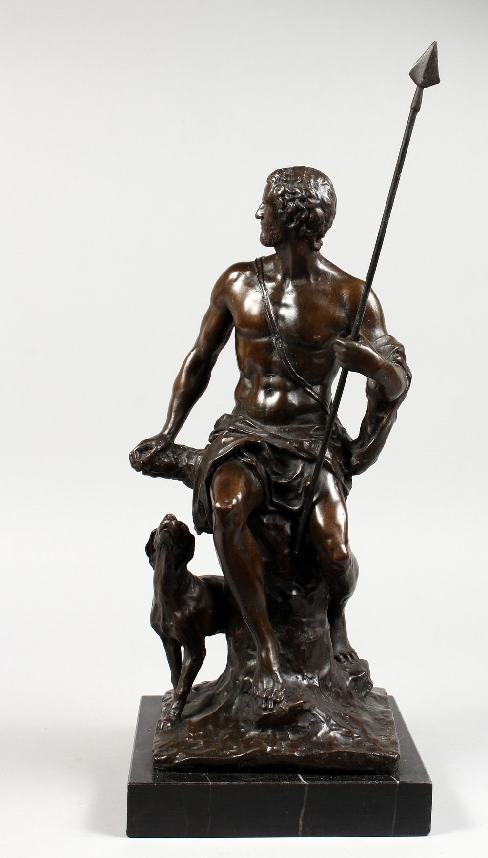 AFTER BONHEUR A LARGE BRONZE FIGURE OF A CLASSICAL MAN holding a spear, a dog by his side. Signed,