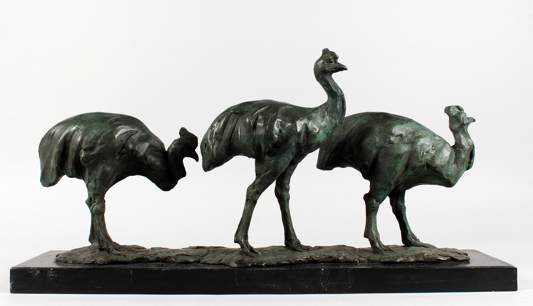 AFTER FREMIET A LONG BRONZE GROUP OF THE EMUS, on a black marble base. Signed. 24ins long.