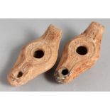 TWO SMALL TERRACOTTA OIL LAMPS.