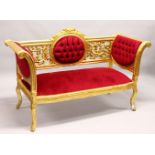 A LOUIS XVI STYLE GILT FRAMED SETTEE, with crimson upholstery. 5ft 1ins long.