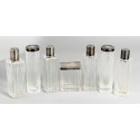 SEVEN SILVER TOP SCENT BOTTLES.