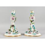 A GOOD PAIR OF MEISSEN FLOWER ENCRUSTED CANDLESTICKS with scrolls. Cross swords mark in blue. 9.5ins