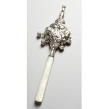 A SILVER RATTLE, with mother-of-pearl handle. 7ins long.