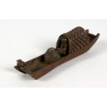 A SMALL JAPANESE BRONZE OF A BOAT. 3.75ins long.