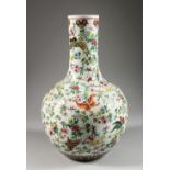 A LARGE CHINESE PORCELAIN BOTTLE VASE, painted with butterflies. 14.75ins high.