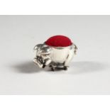 A MINIATURE SILVER PIG PIN CUSHION. 1ins long.