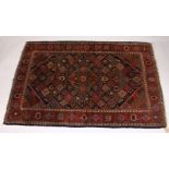 A KASHAN RUG, 20th Century dark blue ground with allover stylized emblems. 6ft 8ins x 4ft 3ins.