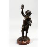 AFTER CLODION A BRONZE FIGURE OF A CUPID, on a circular marble base. Signed. 10ins high.