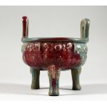 A CHINESE PURPLE SPLASH TWIN-HANDLED POTTERY CENSER ON THREE LEGS. 6ins wide.