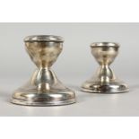 A PAIR OF DWARF SILVER CANDLESTICKS. Birmingham 1974. 2.25ins high.