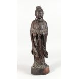 A CHINESE CARVED HARDWOOD FIGURE OF GUANYIN. 20ins high.